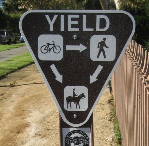 Yield sign with 3-way diagram with icons and arrows.