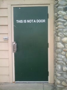 Photo of a door with a sign that says This Is Not a Door.