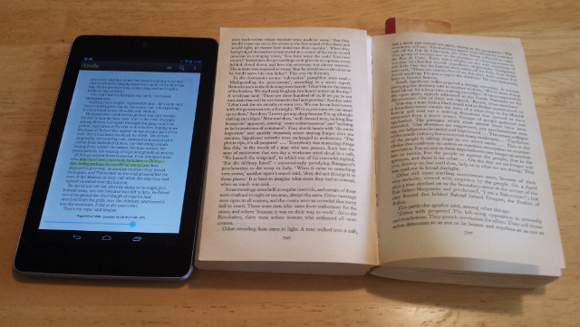 A tablet and a breaking paperback.