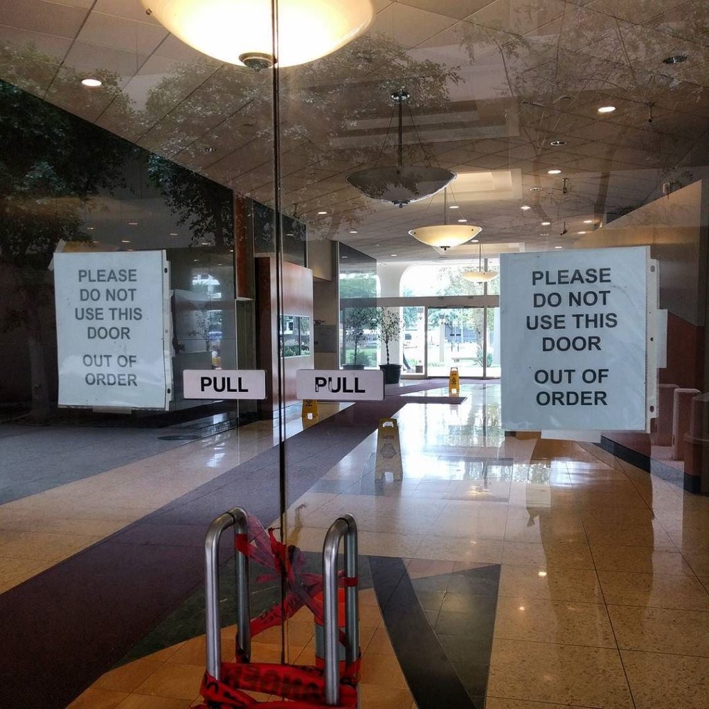 Two doors with signs reading "PLEASE DO NOT USE THIS DOOR OUT OF ORDER"