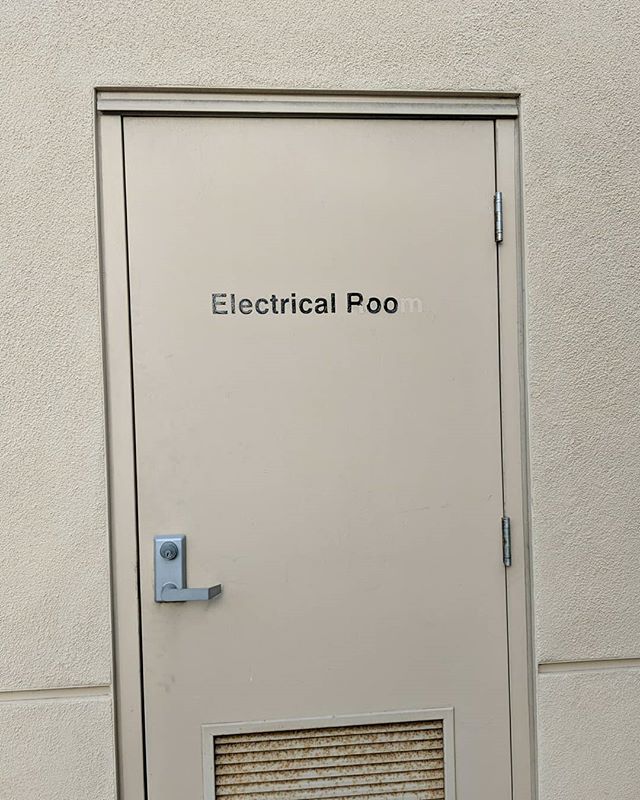 Door with sign: ELECTRICAL POO (originally ELECTRICAL ROOM, but someone scraped off parts of the letters)