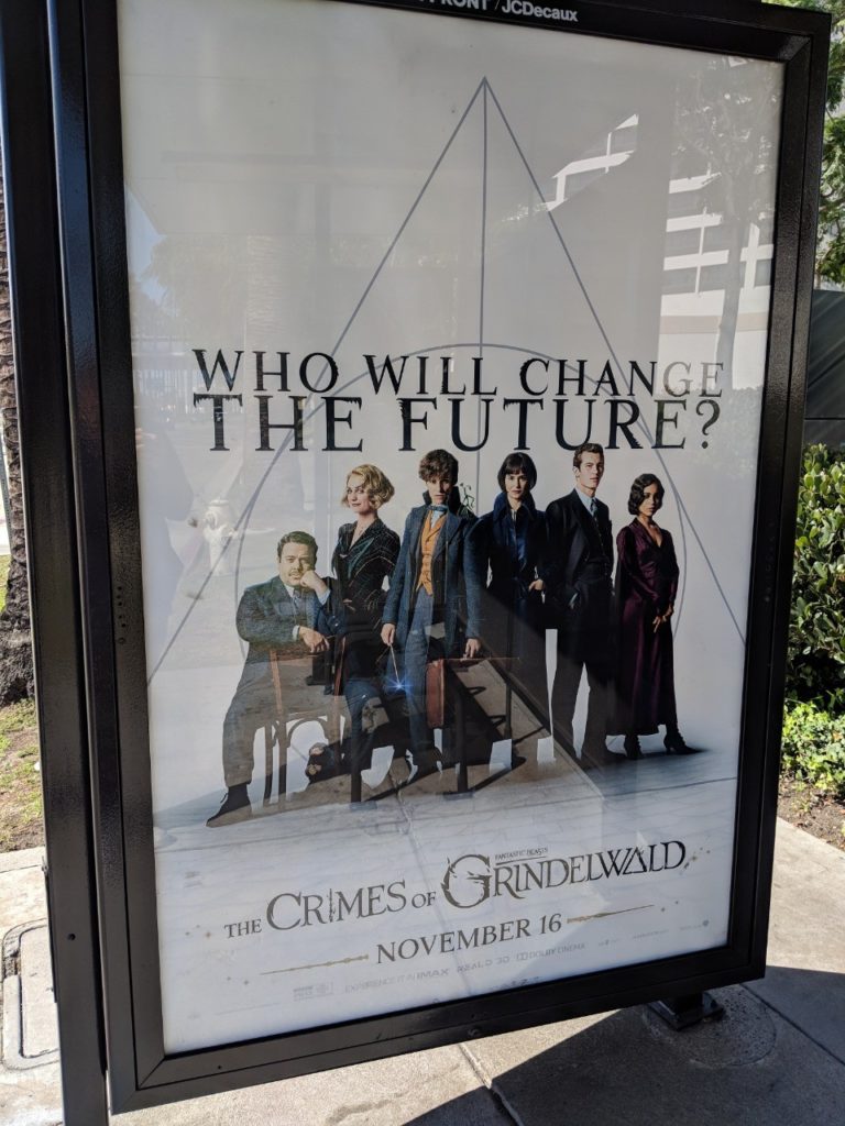Poster: plain white background, characters lined up, with the movie title, "Who will change the future?" And the sign of the Deathly Hallows in the background.
