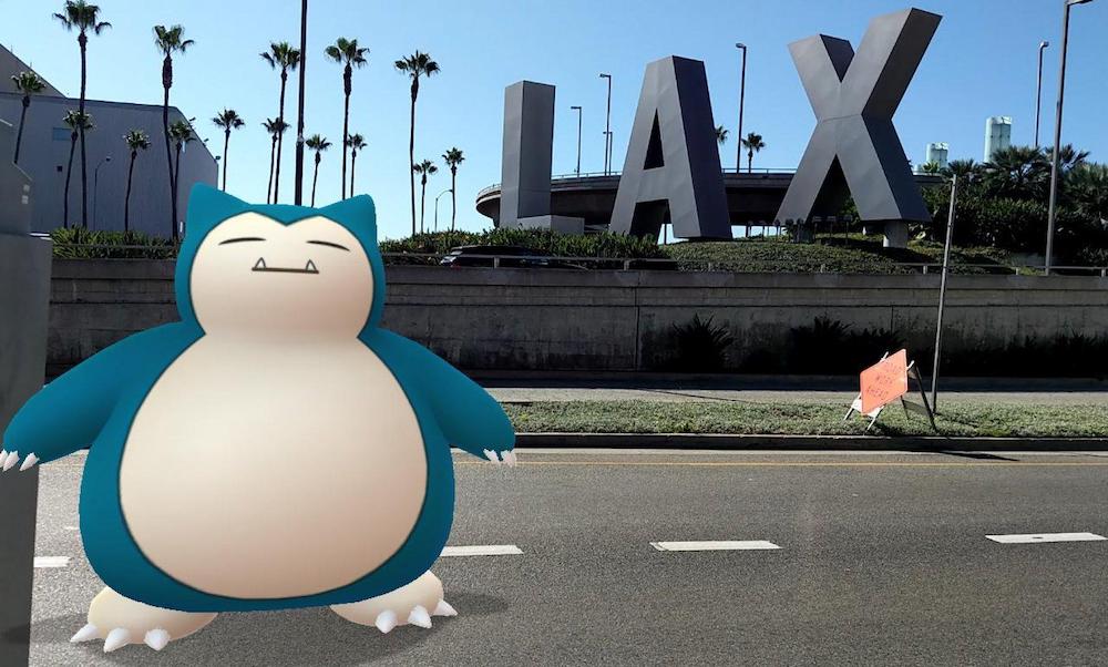 A Snorlax from Pokemon Go superimposed on the road in front of a giant free-standing LAX sign.