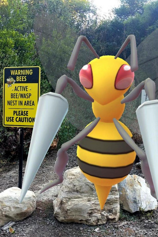 Giant Beedril next to a sign saying Warning: Bees in the area!