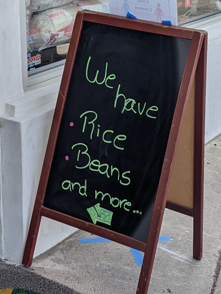 Stand-up sign: We have rice, beans, and more...