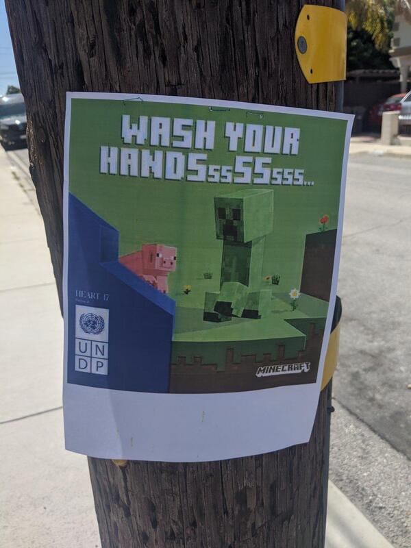 Sign on a telephone pole: a Minecraft Creeper captioned WASH YOUR HANDSSSsssSSS