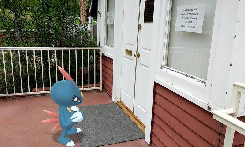 A Pokemon looking at a door with a sign saying that the place is closed.