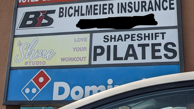 Store signs including Shapeshift Pilates